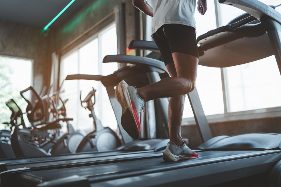 Runner de atleta que trabaja en la cinta de correr en el Fitness Club. Entrenamiento cardiovascular. Estilo de vida saludable, educación para niños en el gimnasio. Concepto de trabajo deportivo